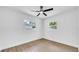 Bedroom features wood floors, ceiling fan, and natural light from two windows at 1416 Murray Ave, Clearwater, FL 33755