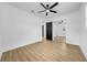Bedroom featuring modern flooring, neutral walls, a ceiling fan and a mirrored closet at 1416 Murray Ave, Clearwater, FL 33755