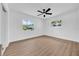 A bedroom featuring modern flooring, neutral walls, and natural light from two windows at 1416 Murray Ave, Clearwater, FL 33755