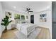 Bright bedroom features large windows, neutral paint, and a modern ceiling fan at 1416 Murray Ave, Clearwater, FL 33755