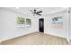 Bedroom with hardwood floors, ceiling fan, freshly painted walls, and natural lighting at 1416 Murray Ave, Clearwater, FL 33755