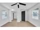 Bright bedroom features hardwood floors, two windows, closet with mirrored doors at 1416 Murray Ave, Clearwater, FL 33755