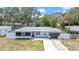 Charming single-story home featuring fresh white paint, black accents and an attached garage at 1416 Murray Ave, Clearwater, FL 33755