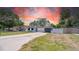 Charming single-story home featuring a modern design, well-manicured lawn, and a fenced yard at 1416 Murray Ave, Clearwater, FL 33755
