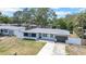 Charming single-story home featuring a modern design, well-manicured lawn, and a fenced yard at 1416 Murray Ave, Clearwater, FL 33755