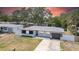 Charming single-story home featuring a modern design, well-manicured lawn, and a fenced yard at 1416 Murray Ave, Clearwater, FL 33755
