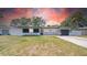 Charming single-story home featuring fresh white paint, black accents and an attached garage at 1416 Murray Ave, Clearwater, FL 33755