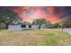 Charming single-story home featuring fresh white paint, black accents and an attached garage at 1416 Murray Ave, Clearwater, FL 33755
