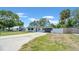 Charming single-story home featuring a long driveway, and an attached garage at 1416 Murray Ave, Clearwater, FL 33755