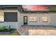 A close view featuring the home's front entrance with its brick-paved patio at 1416 Murray Ave, Clearwater, FL 33755
