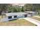 Beautifully renovated home with manicured lawn, modern exterior, and attached garage at 1416 Murray Ave, Clearwater, FL 33755