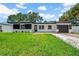 Charming single-story home with well-manicured lawn, updated exterior, and attached garage at 1416 Murray Ave, Clearwater, FL 33755