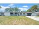 Charming single-story home with well-manicured lawn, updated exterior, and attached garage at 1416 Murray Ave, Clearwater, FL 33755