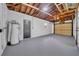 An attached garage with a new water heater and exposed ceiling at 1416 Murray Ave, Clearwater, FL 33755