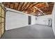 Attached garage featuring a new water heater, painted walls, and smooth floor at 1416 Murray Ave, Clearwater, FL 33755