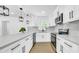 Updated kitchen with white cabinets, stainless steel appliances, and sleek countertops at 1416 Murray Ave, Clearwater, FL 33755