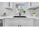 Close up of a kitchen sink with matte black fixtures and quartz countertops at 1416 Murray Ave, Clearwater, FL 33755