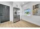 Bright kitchen area featuring stainless steel refrigerator and access door at 1416 Murray Ave, Clearwater, FL 33755