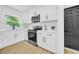 An updated kitchen features stainless steel appliances and shaker cabinets at 1416 Murray Ave, Clearwater, FL 33755