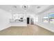 Open-concept living area flows seamlessly to a modern kitchen with stainless appliances and lots of light at 1416 Murray Ave, Clearwater, FL 33755
