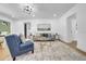 Bright living room with hardwood floors, gray sofa with blue pillows, and stylish coffee table at 1416 Murray Ave, Clearwater, FL 33755