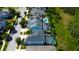 An aerial view displays backyard pools and screened-in patios in a neighborhood close to trees and landscaping at 14975 Renaissance Ave, Odessa, FL 33556