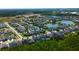 Aerial view showing a community of homes near bodies of water and a beautiful landscape at 14975 Renaissance Ave, Odessa, FL 33556