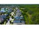 An aerial view showcases a neighborhood with homes, pools, and landscaping near lush greenery at 14975 Renaissance Ave, Odessa, FL 33556