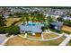 Community clubhouse and pool area with palm trees, manicured lawns, and neighborhood homes in the background at 14975 Renaissance Ave, Odessa, FL 33556