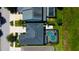 An overhead view shows backyard pools and decks in a tidy neighborhood near green spaces and landscaping at 14975 Renaissance Ave, Odessa, FL 33556