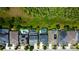 Aerial view of residences with private backyard pools surrounded by green lawns and mature trees, creating a serene atmosphere at 14975 Renaissance Ave, Odessa, FL 33556