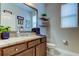 Well-lit bathroom features granite counters, modern fixtures, and decorative shelving at 14975 Renaissance Ave, Odessa, FL 33556