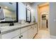 Elegant bathroom boasts dual sinks, granite countertops, and a large walk-in closet at 14975 Renaissance Ave, Odessa, FL 33556