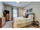 Cozy bedroom features neutral walls, plush carpeting, and a comfortable queen-sized bed at 14975 Renaissance Ave, Odessa, FL 33556