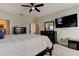 Bedroom with a black dresser, a large television, and neutral carpeting at 14975 Renaissance Ave, Odessa, FL 33556