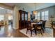 Elegant dining room featuring an ornate hutch, decorative chandelier and plantation shutters at 14975 Renaissance Ave, Odessa, FL 33556