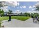 Well-maintained community dog park featuring a grassy area, seating, and waste station for residents at 14975 Renaissance Ave, Odessa, FL 33556