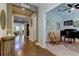 Inviting entryway with wood floors flowing into a living area and a separate home office at 14975 Renaissance Ave, Odessa, FL 33556