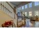 View of staircase from foyer showing light filled living room beyond at 14975 Renaissance Ave, Odessa, FL 33556
