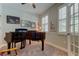 Comfortable home office with natural light from plantation shutters and a ceiling fan at 14975 Renaissance Ave, Odessa, FL 33556