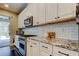 Well-equipped kitchen with white cabinets, granite countertops, subway tile backsplash, and stainless steel appliances at 14975 Renaissance Ave, Odessa, FL 33556