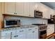 Stylish kitchen features white cabinets, granite countertops, and stainless steel appliances at 14975 Renaissance Ave, Odessa, FL 33556