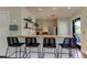 A functional kitchenette includes counter seating, shelving, and essential appliances, perfect for quick snacks and beverages at 14975 Renaissance Ave, Odessa, FL 33556