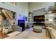 A spacious living room with high ceilings, a large TV, stylish shelves, and comfortable seating arrangements at 14975 Renaissance Ave, Odessa, FL 33556