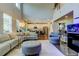 Open concept living space with high ceilings, ample natural light, and modern furnishings, seamlessly connecting to the kitchen at 14975 Renaissance Ave, Odessa, FL 33556