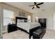 Luxurious bedroom featuring a king bed, dual windows, and elegant dark furniture at 14975 Renaissance Ave, Odessa, FL 33556