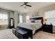 Spacious bedroom boasts a large bed with bench seating and a decorative wall hanging at 14975 Renaissance Ave, Odessa, FL 33556