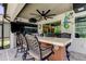 Covered bar area with outdoor seating and a view of the backyard at 14975 Renaissance Ave, Odessa, FL 33556