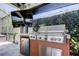 The covered patio features a stainless steel grill and mini fridge, perfect for outdoor entertaining at 14975 Renaissance Ave, Odessa, FL 33556