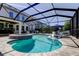 A beautiful screened-in pool with a spa and outdoor bar area is perfect for entertaining guests at 14975 Renaissance Ave, Odessa, FL 33556